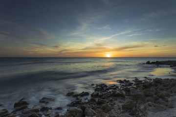 Gorgeous colorful view of sunset on Aruba. Beautiful nature landscape. Rocky coast of Atlanta, Caribbean.	