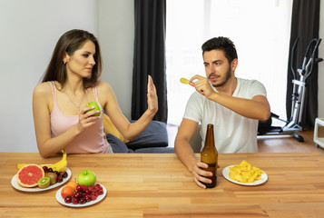 A man leads a wrong lifestyle, he eats chips and beer.