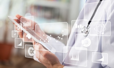 Female doctor using digital tablet, close up on hands