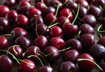 Red ripe fresh cherries in drops of water close-up. Cherry background. Berry pattern and texture. Food background.