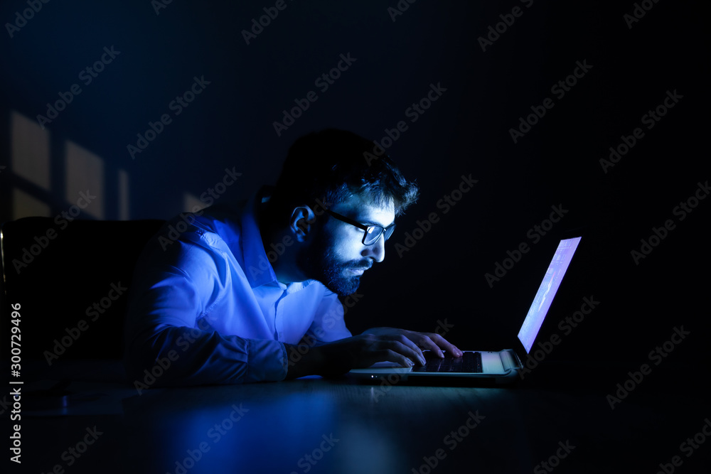 Poster man working in computer at the night