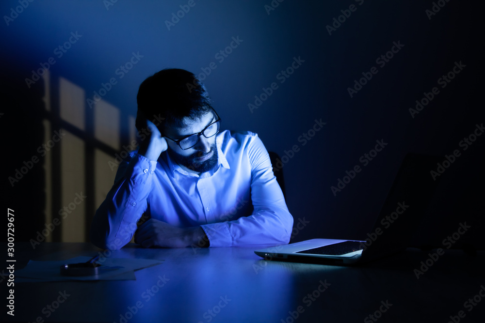 Poster man working in computer at the night