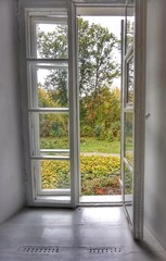 Window to the autumn park in the old manor.