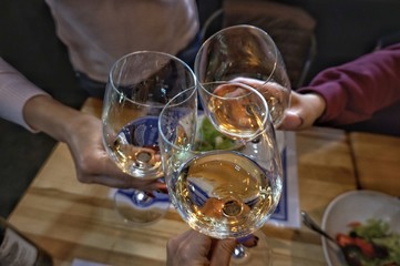 Three glasses of wine in female hands. Toast.