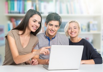 Group of Students with computer at lesson in classroom