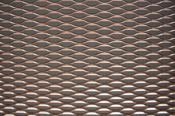 Close up view of bronze colored metal mesh background.