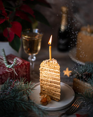 Homemade honey cake. Winter composition. New Year photo. Christmas decoration. Christmas decorations. Cake with sparklers. Candles. Snow.