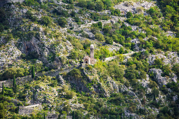 Fototapeta na wymiar Ancient walls of Kotor Fort (St John Fortress) and Chapel of Our Lady of Salvation in the mountains slope of Kotor town, Montenegro 