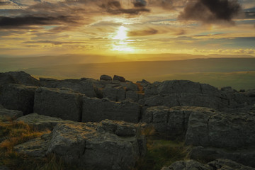 Stunning sunset from the rocky outcrop at the top of Great Whernside overlooking Wharfedale, Yorkshire Dales, UK