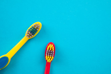 Teeth brushing concept. Toothbrushes on blue background top view.