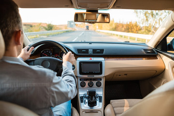 The man driving the modern car