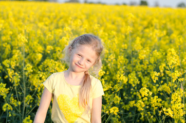 Fototapeta premium charming blond girl relaxing in yellow meadow