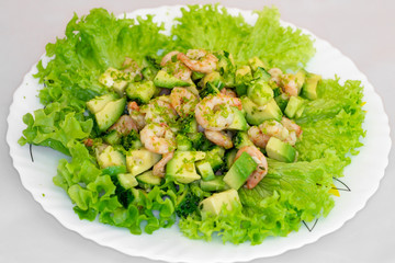 fresh salad with avocado and shrimp  on a plate