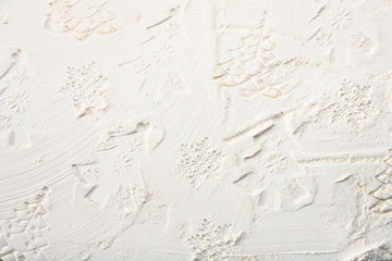 Contours of decorative Christmas trees and decorations on flour. Christmas white texture background.