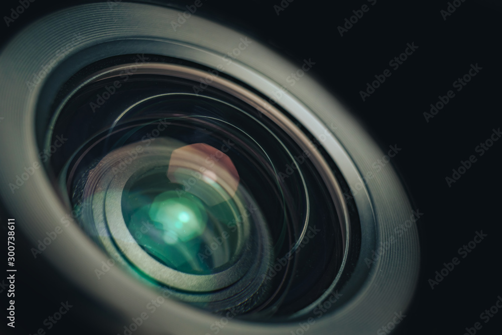 Poster close up beautiful camera lens on a black background. macro view..