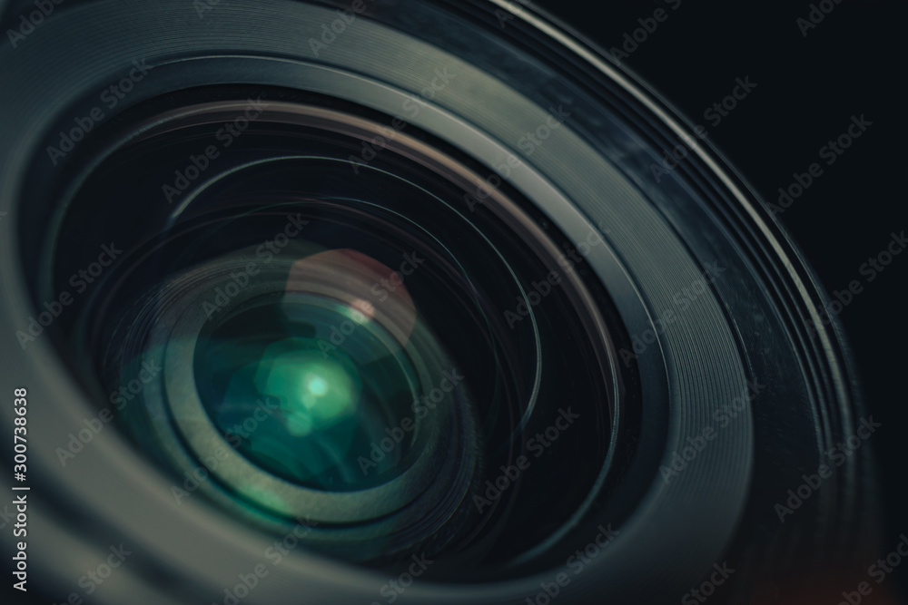 Poster close up beautiful camera lens on a black background. macro view..