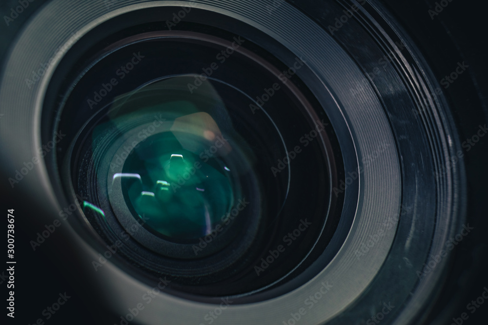 Poster close up beautiful camera lens on a black background. macro view..