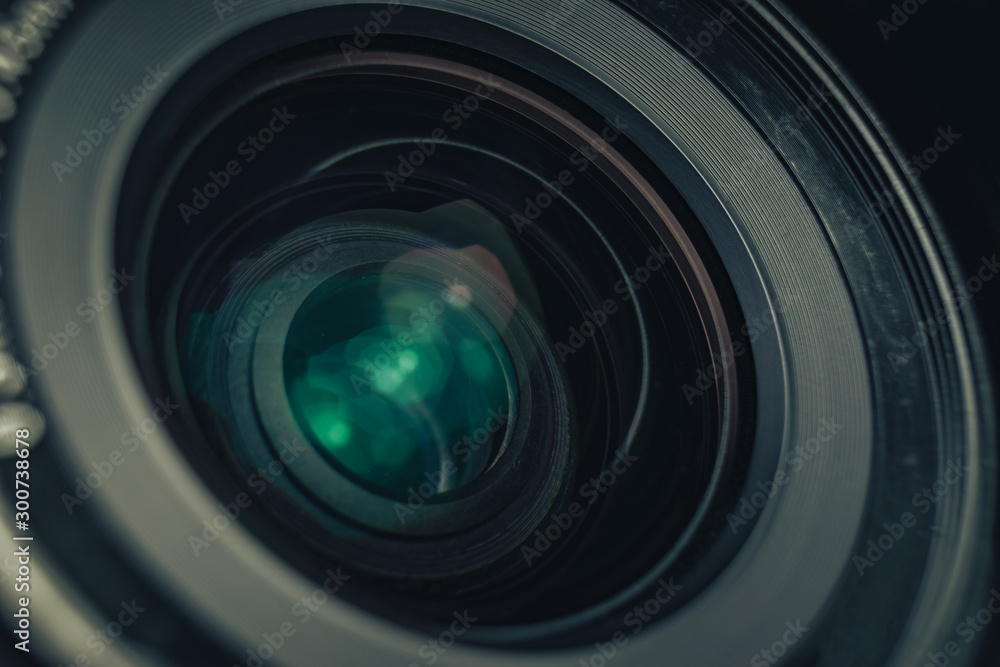Poster close up beautiful camera lens on a black background. macro view..