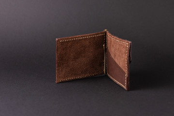 leather wallets on a black background with space for an inscription. Leather craft concept.