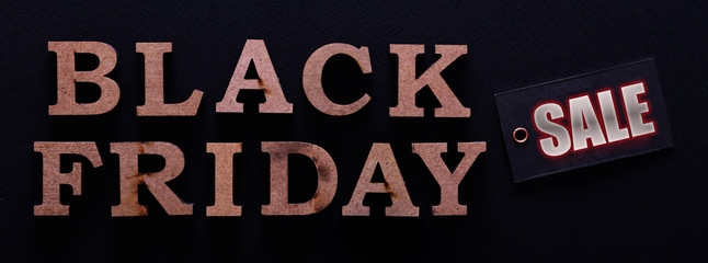 Black friday sale concept. Fourth Friday of November, beginning of Christmas shopping season since 1952. Price tag with text on paper textured background. Copy space, close up, top view, flat lay
