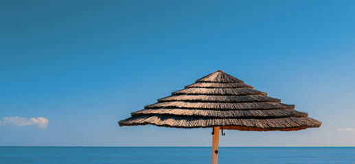 reed beach umbrellas on a deserted beach