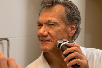 Man Shaving with an Electric Razor or Shaver