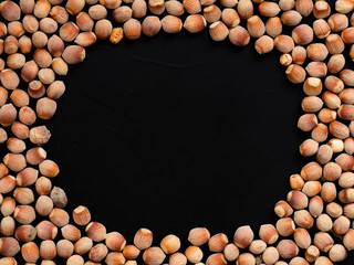 Natural organic hazelnut on a black background. Top view. Healthy eating concept. Natural light. Food background, copy space - photo wallpaper.