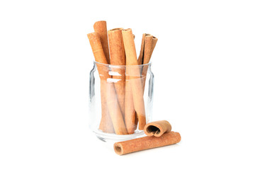 Cinnamon sticks in glass jar isolated on white background