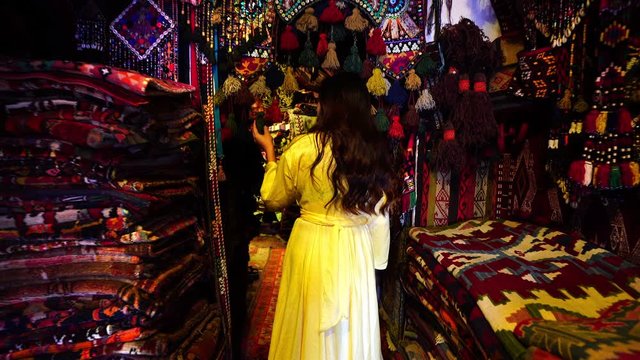 Tourist walking at traditional carpet shop in Goreme city, Cappadocia in Turkey.