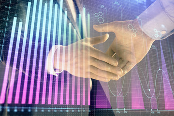 Obraz na płótnie Canvas Multi exposure of forex graph on abstract background with two businessmen handshake. Concept of success on stock market