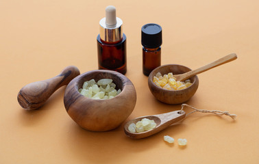 Chios mastic tears and essential oil on orange color background