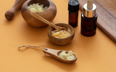 Chios mastic tears and essential oil on orange color background