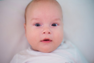 Closeup portrait of a baby in bed.