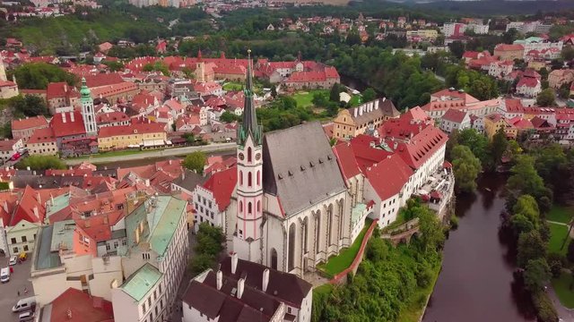 Cesky Krumlov, view on the cathedral from the dron. Old city in The Cech Republic- Cesky Krumlov. Cloudy day in the city. Red roofs in the city.