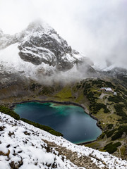 Turquoise lake Drachensee in fog