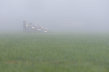 empty soccer bleacher seats on misty morning