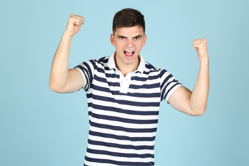 Young happy man on blue background