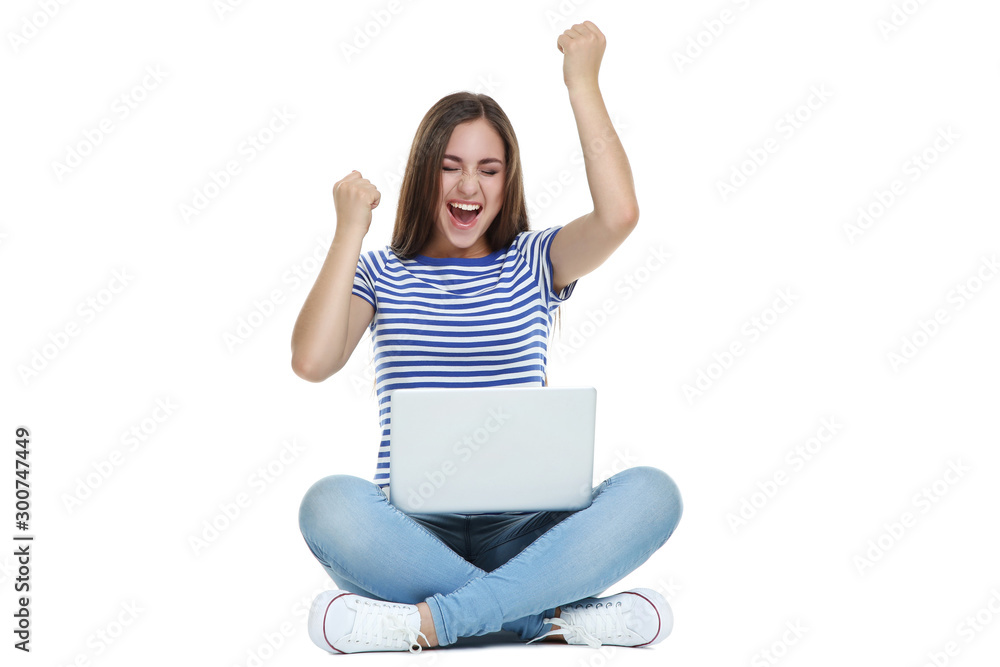 Wall mural Young girl with laptop computer sitting on white background