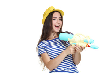 Young girl with water gun isolated on white background