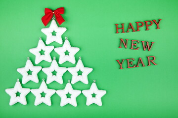Christmas background with a Christmas tree of white stars and the words happy new year