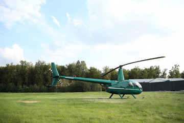  green helicopter on the lawn in summer