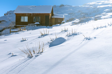 Isolated house covered by snow. Andes mountain, Chile