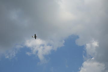 light aircraft in the sky with clouds