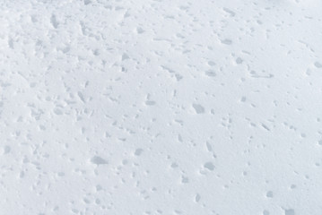 Compressed snow texture.  Natural formation with small holes