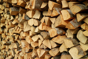 Pile of the cut wood logs in the firewood storage