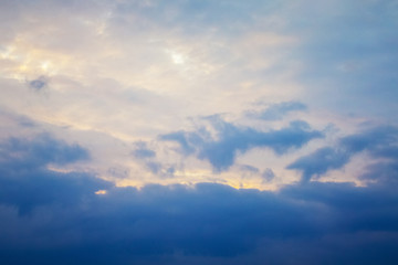 Dark clouds in the evening sky in the glare of the sun_