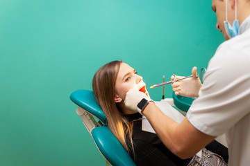 Patient woman is given an analgesic injection to treat a tooth. Dentist gives an painkiller injection.