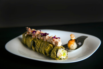 Plate with a sushi roll and a gourmet nigiri