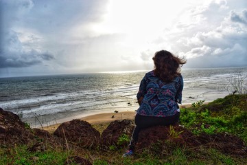 woman sitting on top of mountain