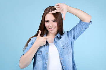 Young beautiful woman on blue background